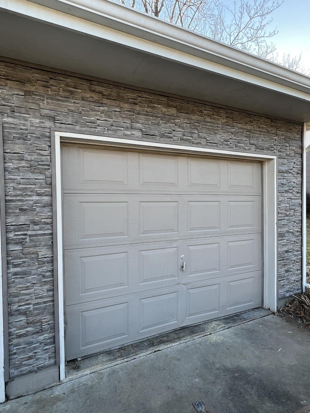 Garage front finished with gray stacked-stone veneer